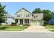 Charming two-story home with a welcoming front porch and well-maintained green lawn at 11324 Fullerton Place Nw Dr, Huntersville, NC 28078