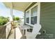 Charming front porch with white Adirondack chairs and a small table, perfect for enjoying the outdoors at 11324 Fullerton Place Nw Dr, Huntersville, NC 28078