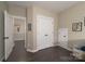 Hallway with closet space, dark wood floors and view of two bedrooms at 11324 Fullerton Place Nw Dr, Huntersville, NC 28078