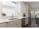 Bright kitchen with stainless steel appliances, white cabinets, and a view to the backyard at 11324 Fullerton Place Nw Dr, Huntersville, NC 28078
