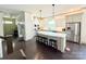 Modern kitchen with stainless steel appliances, a center island, and dark wood flooring at 11324 Fullerton Place Nw Dr, Huntersville, NC 28078
