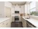 Well-equipped kitchen with stainless steel appliances, white cabinets, and stylish countertops at 11324 Fullerton Place Nw Dr, Huntersville, NC 28078