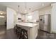Bright kitchen with stainless steel appliances, quartz countertops, white cabinets, and large island at 11324 Fullerton Place Nw Dr, Huntersville, NC 28078