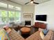 Bright and airy living room with large windows, a fireplace, and modern furnishings at 11324 Fullerton Place Nw Dr, Huntersville, NC 28078