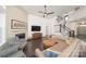 Cozy living room featuring a fireplace, hardwood floors, and comfortable seating at 11324 Fullerton Place Nw Dr, Huntersville, NC 28078