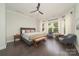 Spacious main bedroom with a ceiling fan, bench seating, and large bay windows at 11324 Fullerton Place Nw Dr, Huntersville, NC 28078