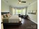Cozy main bedroom featuring large windows and wood floors, creating a relaxing atmosphere at 11324 Fullerton Place Nw Dr, Huntersville, NC 28078