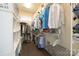 Walk-in closet with storage shelves, hanging clothes, and hardwood floors at 11324 Fullerton Place Nw Dr, Huntersville, NC 28078