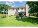 Well-manicured backyard featuring a lush lawn and inviting outdoor seating area for relaxation at 11802 Fox Glen Rd, Charlotte, NC 28269