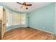 Bedroom with multiple windows providing ample natural light and views, paired with wood flooring at 11802 Fox Glen Rd, Charlotte, NC 28269
