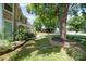 Landscaped front yard with flowering bushes and retaining wall, mature shade trees and curved sidewalk at 11802 Fox Glen Rd, Charlotte, NC 28269