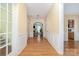 Spacious hallway with wood floors and architectural details leads to the living room and kitchen at 11802 Fox Glen Rd, Charlotte, NC 28269