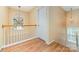 Hallway with light wood floors, a decorative light fixture, and a window at 11802 Fox Glen Rd, Charlotte, NC 28269