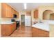 Well-lit kitchen with wood cabinets, white countertops, and modern appliances at 11802 Fox Glen Rd, Charlotte, NC 28269