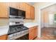 Well-equipped kitchen with modern stainless steel appliances and wood cabinetry at 11802 Fox Glen Rd, Charlotte, NC 28269
