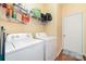 Practical laundry room equipped with a washer, dryer, and wire shelving for optimal storage at 11802 Fox Glen Rd, Charlotte, NC 28269