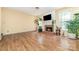Bright living room featuring a brick fireplace, wood floors, and ample natural light at 11802 Fox Glen Rd, Charlotte, NC 28269