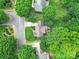 Aerial view showing a home with a screened porch, a deck, a well-manicured lawn, and mature trees at 1201 Beckford Glen Dr, Waxhaw, NC 28173