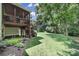 Serene backyard featuring a wooden deck, screened porch, landscaped garden beds, and a spacious lawn at 1201 Beckford Glen Dr, Waxhaw, NC 28173