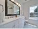 Elegant bathroom with double sinks, a large mirror, and a well-lit vanity at 1201 Beckford Glen Dr, Waxhaw, NC 28173