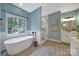 Bright bathroom features standalone tub, separate shower, and stylish fixtures at 1201 Beckford Glen Dr, Waxhaw, NC 28173