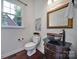 Powder room with stylish vessel sink, decorative mirror, and wood floors at 1201 Beckford Glen Dr, Waxhaw, NC 28173