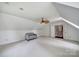 Bright, spacious bonus room featuring neutral decor, a cozy couch, and an open doorway to the staircase at 1201 Beckford Glen Dr, Waxhaw, NC 28173