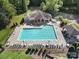 Aerial view of a pristine community pool, clubhouse, and well-maintained landscaping at 1201 Beckford Glen Dr, Waxhaw, NC 28173