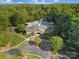 Aerial shot of community pool with water slide, playground, seating, and lush landscaping at 1201 Beckford Glen Dr, Waxhaw, NC 28173