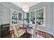 Eat-in dining area features a round table, hardwood floors, and natural lighting from three windows at 1201 Beckford Glen Dr, Waxhaw, NC 28173
