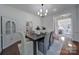 Elegant dining room featuring a chandelier, modern table setting, and bright natural light at 1201 Beckford Glen Dr, Waxhaw, NC 28173