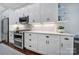 Modern kitchen featuring stainless steel appliances, white cabinetry, and tiled backsplash at 1201 Beckford Glen Dr, Waxhaw, NC 28173