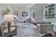 Cozy living room showcasing neutral tones, comfortable seating, and bright natural light from large windows at 1201 Beckford Glen Dr, Waxhaw, NC 28173