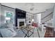 Spacious living room with a fireplace, custom shelving, and large windows for natural light at 1201 Beckford Glen Dr, Waxhaw, NC 28173