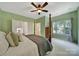 Spacious bedroom with four-poster bed, ceiling fan, and large windows providing natural light at 1201 Beckford Glen Dr, Waxhaw, NC 28173