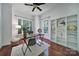 Well-lit home office featuring built-in bookshelves, a modern desk, and hardwood floors at 1201 Beckford Glen Dr, Waxhaw, NC 28173