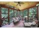 Relaxing screened-in porch with wood ceiling and cozy wicker furniture, offering serene outdoor living space at 1201 Beckford Glen Dr, Waxhaw, NC 28173