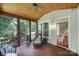 Comfortable screened-in porch with wood ceiling, wicker seating, and stairs that lead inside at 1201 Beckford Glen Dr, Waxhaw, NC 28173