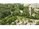 Scenic aerial view overlooking a serene pond, walking trail, and beautiful homes nestled among mature trees at 13528 Philip Michael Rd, Huntersville, NC 28078