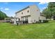 Spacious backyard with well manicured lawn, a patio with furnishings, and an exterior view of the home at 13528 Philip Michael Rd, Huntersville, NC 28078
