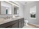 Elegant bathroom with double sinks, marble countertop, modern fixtures, and window at 13528 Philip Michael Rd, Huntersville, NC 28078