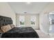 Cozy bedroom featuring two windows bringing in natural light, soft carpeting and a chandelier view, perfect for relaxation at 13528 Philip Michael Rd, Huntersville, NC 28078
