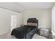 Comfortable bedroom featuring a black bed set, soft carpeting, and matching bedside tables, perfect for relaxation at 13528 Philip Michael Rd, Huntersville, NC 28078