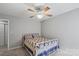 Bedroom featuring a ceiling fan and a comfortable bed with a patterned quilt at 13528 Philip Michael Rd, Huntersville, NC 28078