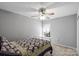 Cozy bedroom featuring a ceiling fan, soft carpeting, and natural light creating a peaceful atmosphere at 13528 Philip Michael Rd, Huntersville, NC 28078