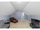 Cozy bonus room with neutral carpet, a leather chaise lounge, and comfortable seating for relaxing and watching TV at 13528 Philip Michael Rd, Huntersville, NC 28078