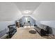 Bright bonus room with a desk and gray couch at 13528 Philip Michael Rd, Huntersville, NC 28078