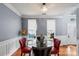 Dining room with hardwood floors, chandelier, and classic wainscoting adjacent to the foyer at 13528 Philip Michael Rd, Huntersville, NC 28078