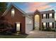 Charming two-story brick home with manicured landscaping and an attached two-car garage at 13528 Philip Michael Rd, Huntersville, NC 28078