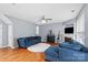 Bright living room with blue sofas, fireplace, and hardwood floors at 13528 Philip Michael Rd, Huntersville, NC 28078